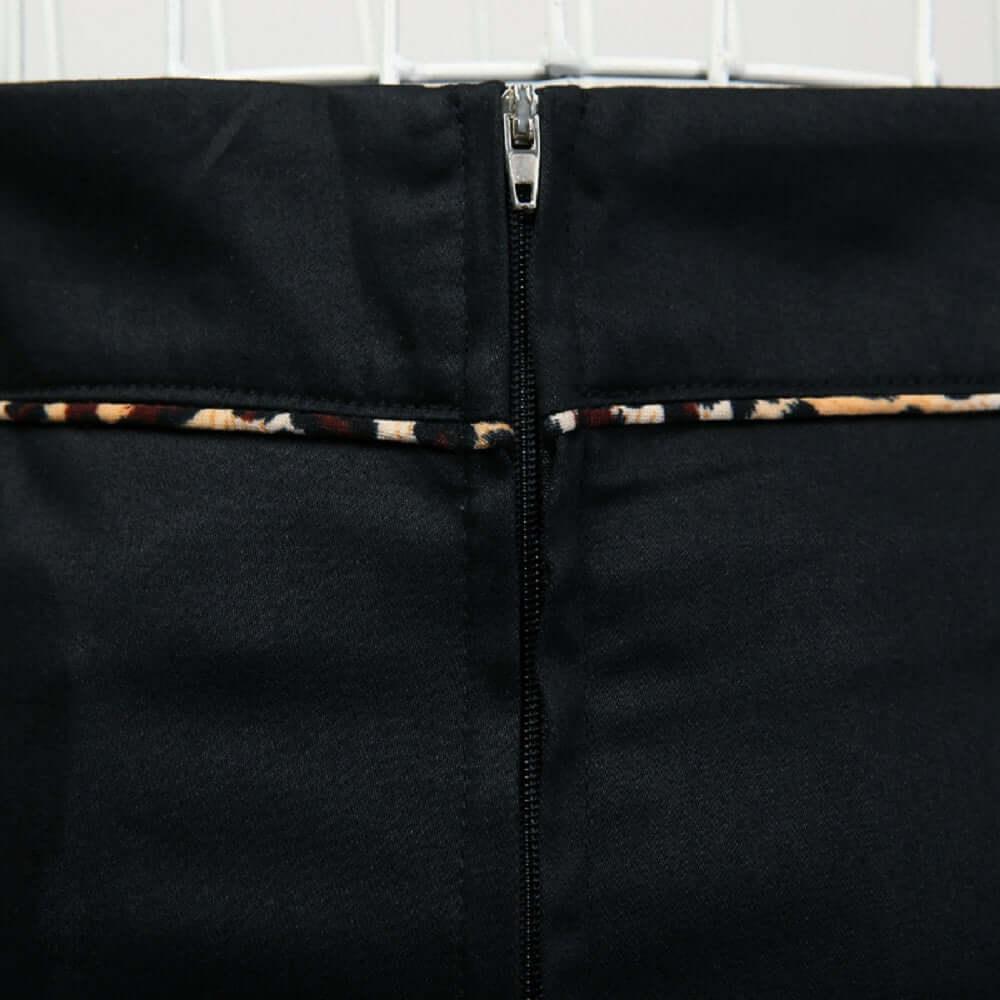Back view of the black pencil skirt featuring leopard piping and a sleek zip closure.