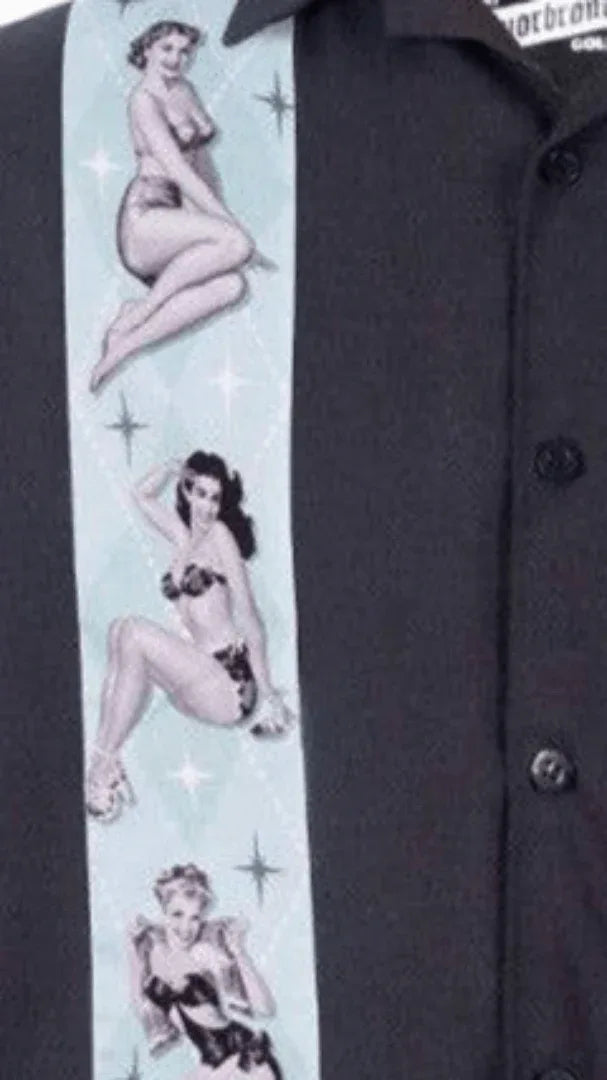 Close-up of the Liquorbrand Vegas Strip Bowling Shirt featuring Hawaiian hula girl print on a black crepe fabric.