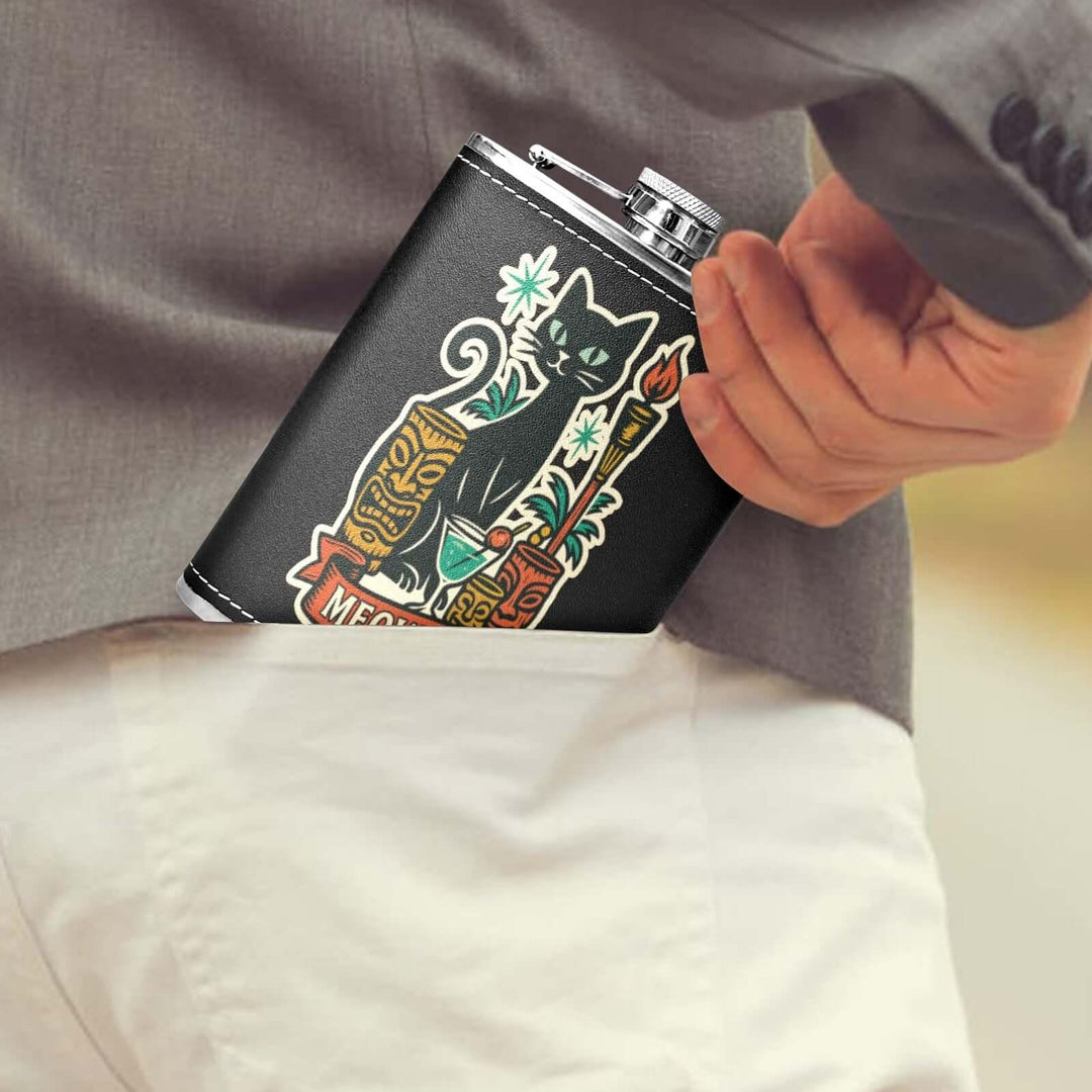 Close-up of a black hip flask with a cat design being placed into a man's back pocket.