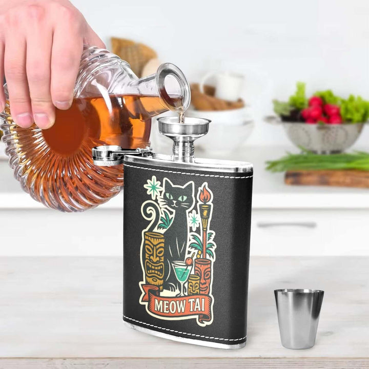 Person pouring a drink into Meow Tai black hip flask with tiki art, perfect for hip flask Australia.
