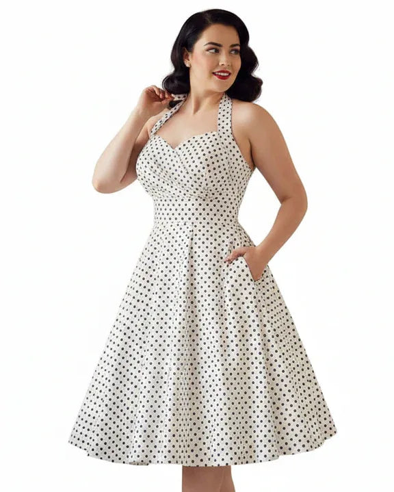White vintage-style women’s halter dress with black polka dots and full swing skirt
