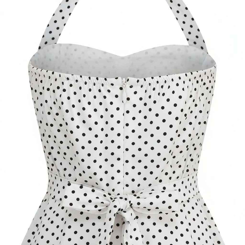 White strapless top with black polka dot pattern on a white background