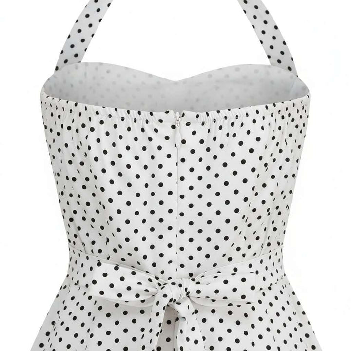 White strapless top with black polka dot pattern on a white background